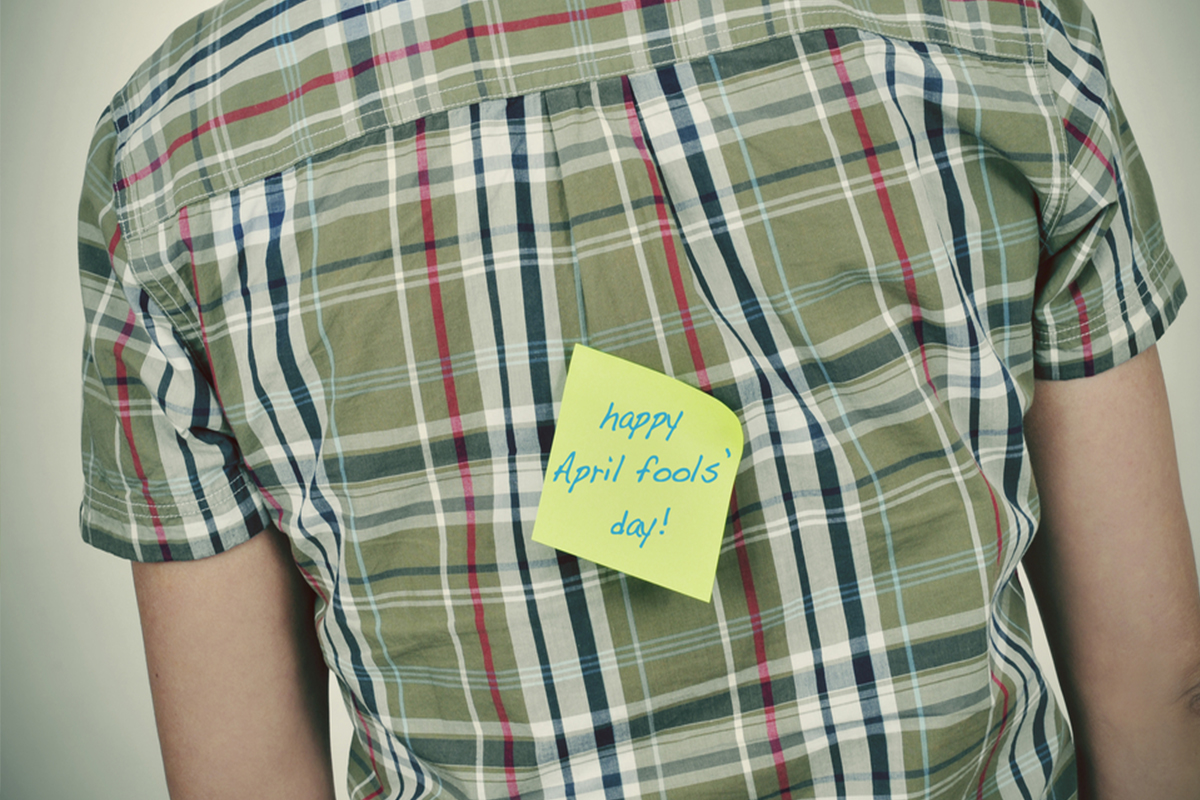 happy april fools day post it note on back of man's shirt