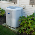 modern air condition unit sits on bricks outside home