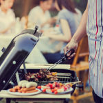 image of a man grilling burgers on a grill