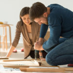 image of a young couple doing a home maintenance project on the floor