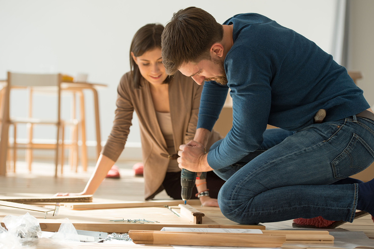 image of a young couple doing a home maintenance project on the floor