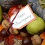 thanksgiving fruits and vegetables on a table with a happy thanksgiving tag