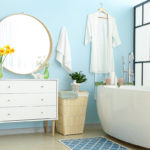 modern bathroom with white tub and blue walls