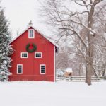 red house with green wreath in snow