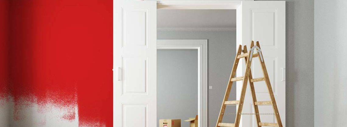 freshly painted red wall with ladder in foreground