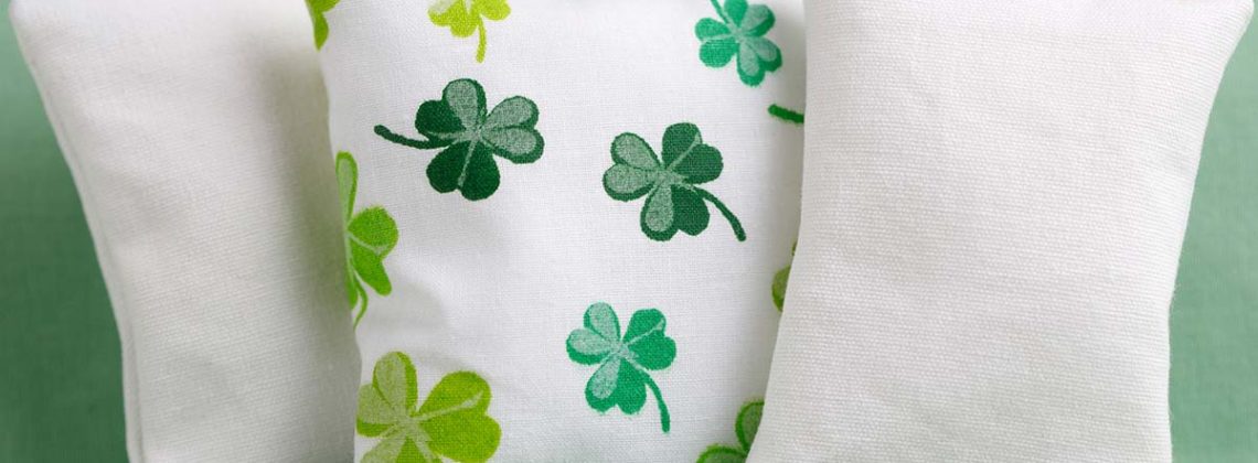 shamrock pillow sits on green couch