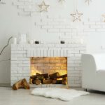 white couch and fireplace against white walls