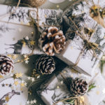 small pinecones sit atop wrapped presents