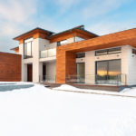 large modern house on snowy lot