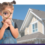 A little girl holding a magnifying glass in front of her face standing in front of a house