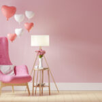 pink chair with pink and white heart-shaped balloons and lamp