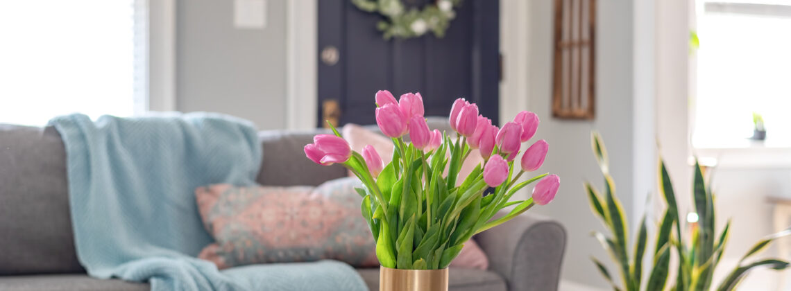 Vase of pink tulips in a cozy home decorated for spring