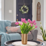 Vase of pink tulips in a cozy home decorated for spring