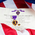 Purple Heart medal with certificate and American flag