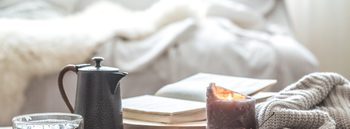 Cozy window nook with a hot drink and candle