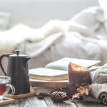 Cozy window nook with a hot drink and candle