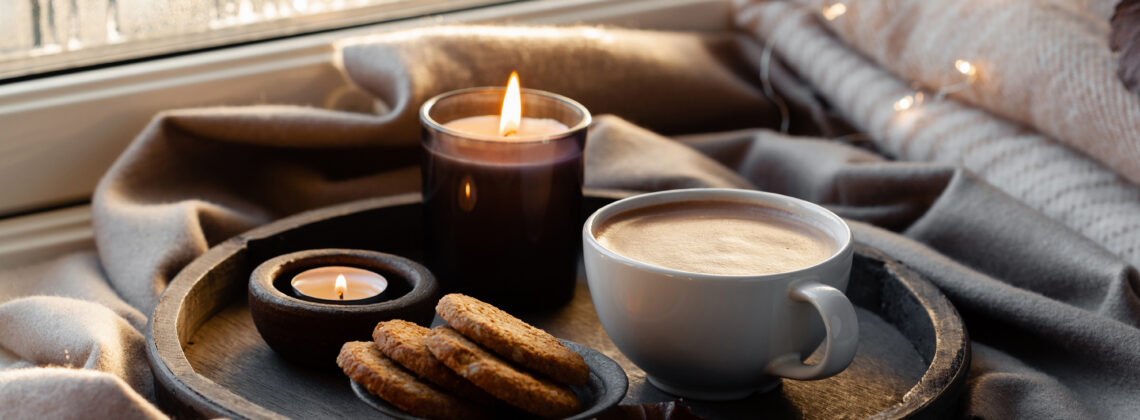 cozy window with hot cocoa, cookies and a candle