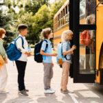 children boarding a school bus